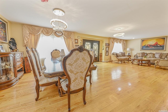 dining space featuring a chandelier and light wood-type flooring