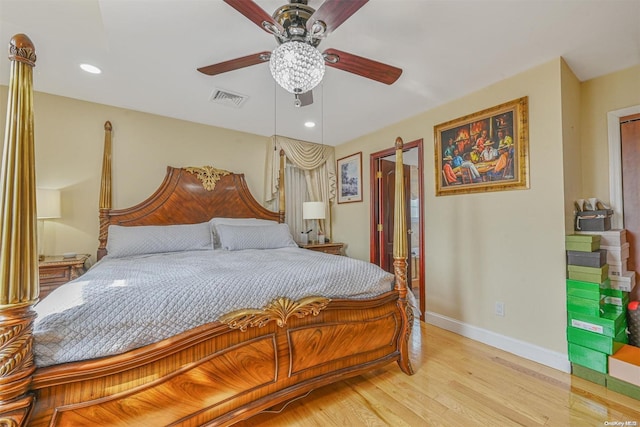 bedroom with ceiling fan and light hardwood / wood-style floors