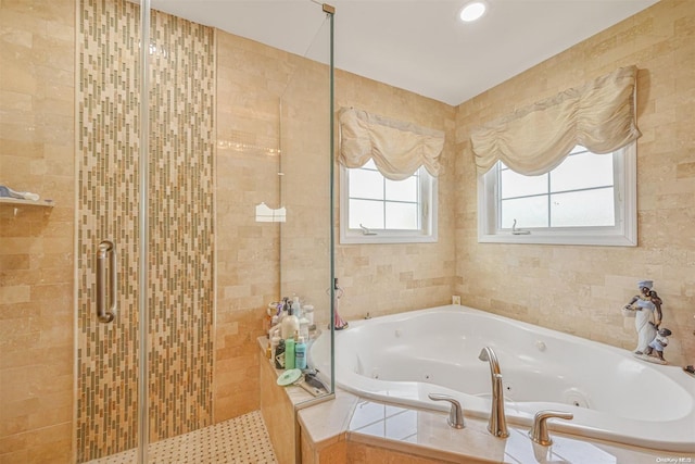 bathroom featuring separate shower and tub and tile walls