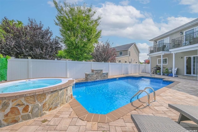 view of swimming pool featuring an in ground hot tub and a patio