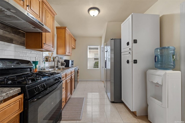 kitchen featuring sink, stainless steel appliances, ventilation hood, washer / clothes dryer, and light tile patterned flooring