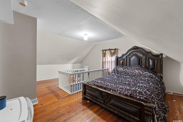 bedroom featuring wood-type flooring and lofted ceiling