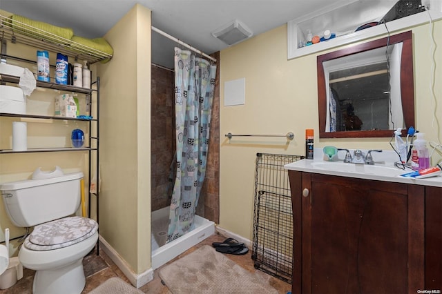 bathroom with tile patterned floors, vanity, toilet, and walk in shower