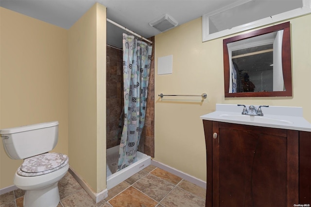 bathroom with vanity, toilet, and walk in shower