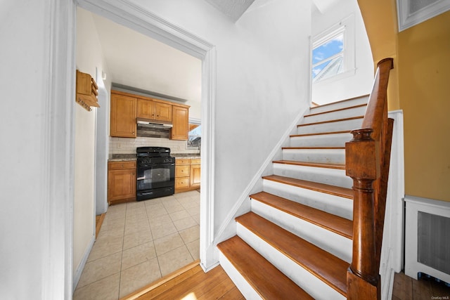 stairs featuring baseboards and tile patterned floors