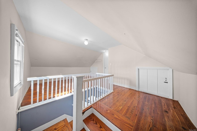 additional living space featuring hardwood / wood-style flooring and vaulted ceiling