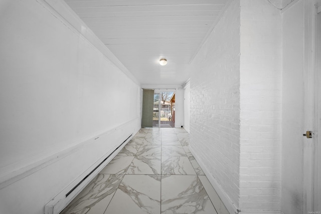 hallway with a baseboard heating unit, marble finish floor, ornamental molding, and brick wall