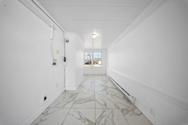 hallway with marble finish floor and baseboard heating