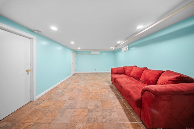 living room featuring recessed lighting, a wall mounted air conditioner, and baseboards