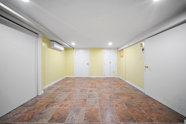 finished below grade area with recessed lighting, an AC wall unit, and baseboards