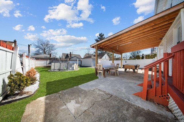 view of patio / terrace featuring outdoor dining space, a fenced backyard, a fenced in pool, and an outdoor structure