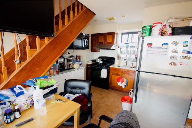 kitchen with black appliances, light tile patterned floors, and sink