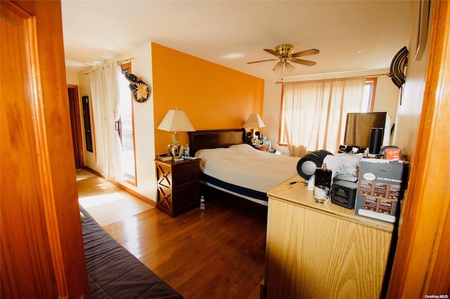 bedroom with ceiling fan and wood-type flooring