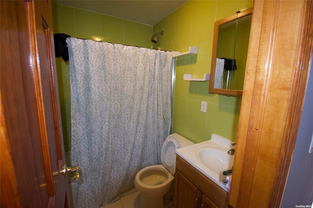 bathroom with walk in shower, vanity, toilet, and tile walls