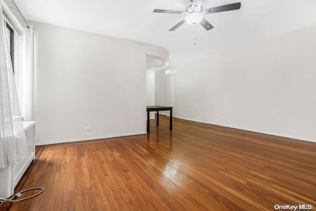 empty room featuring a chandelier and hardwood / wood-style floors