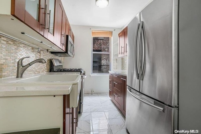 kitchen featuring tasteful backsplash, sink, and stainless steel appliances