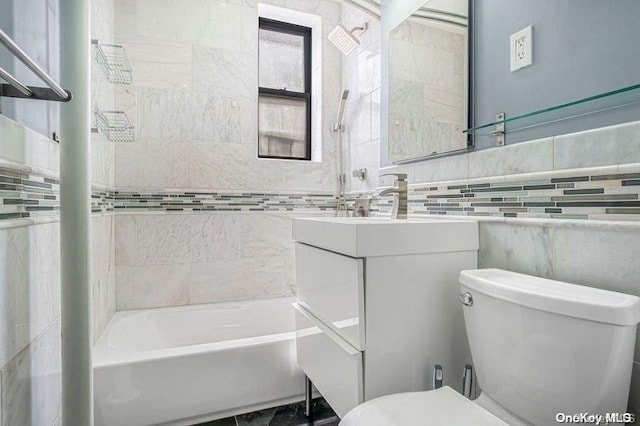 bathroom featuring vanity, toilet, tile walls, and a tub