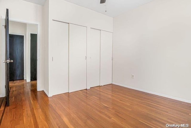 unfurnished bedroom with hardwood / wood-style flooring and ceiling fan