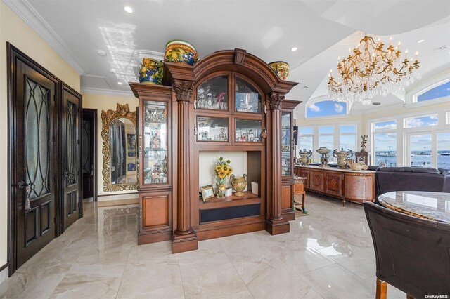 bar featuring a chandelier, a wealth of natural light, and ornamental molding