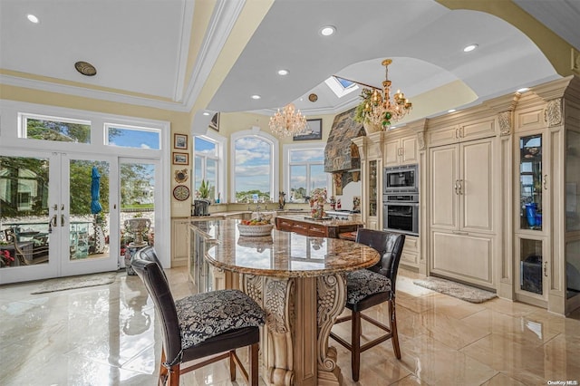 dining space featuring french doors, a chandelier, and ornamental molding