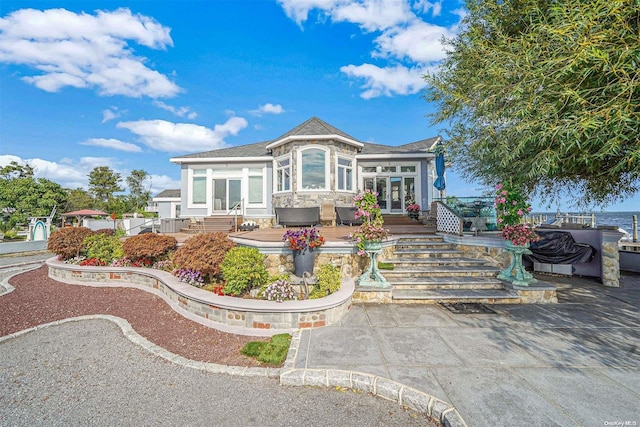 view of front facade featuring a patio area and french doors