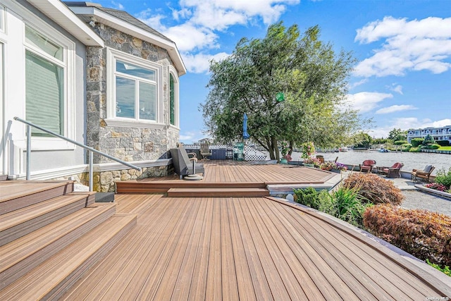 wooden deck featuring a water view