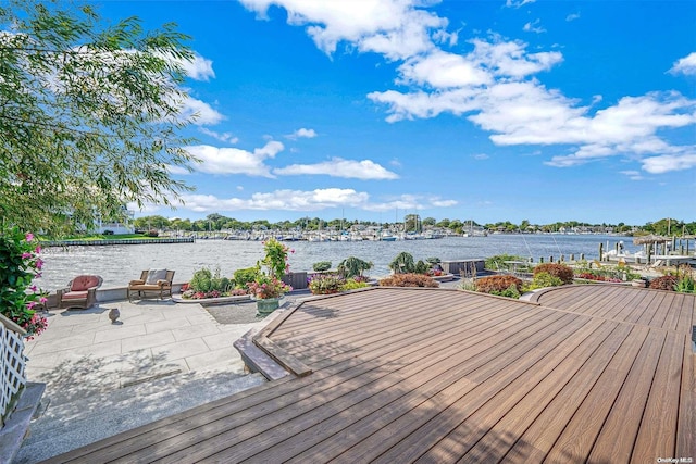 wooden terrace with a patio and a water view