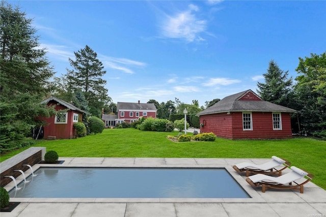 view of pool featuring a yard and a storage unit