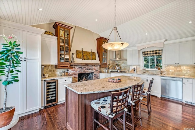 kitchen with a center island, wine cooler, stainless steel dishwasher, decorative light fixtures, and dark hardwood / wood-style flooring