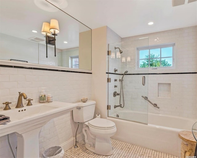 full bathroom featuring backsplash, toilet, enclosed tub / shower combo, and sink