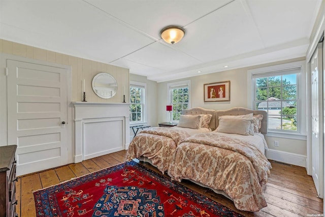 bedroom with multiple windows and light hardwood / wood-style floors