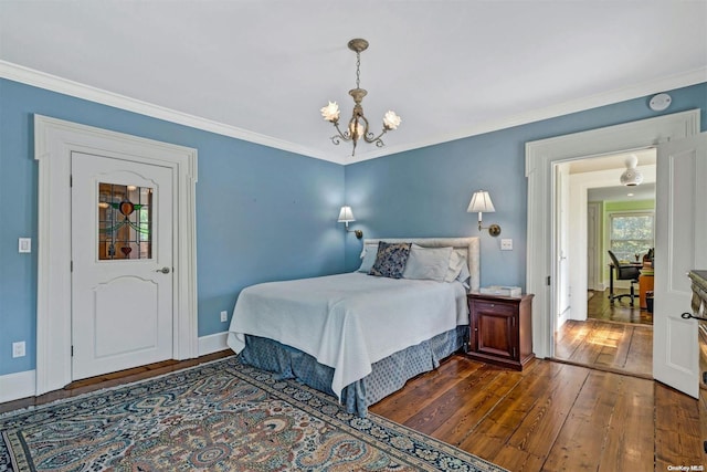 bedroom with dark hardwood / wood-style floors, crown molding, and an inviting chandelier