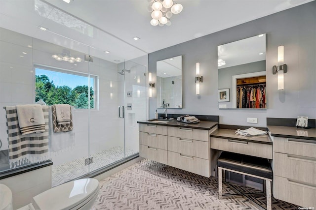 bathroom featuring vanity, toilet, and walk in shower