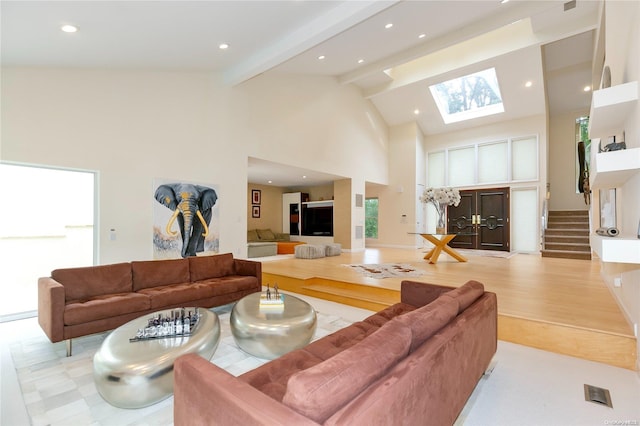 living room with light hardwood / wood-style floors, beam ceiling, and high vaulted ceiling