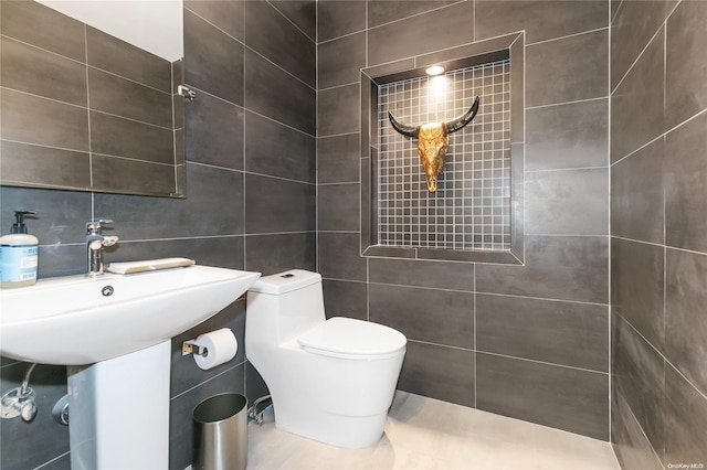 bathroom with toilet, tile walls, and tasteful backsplash