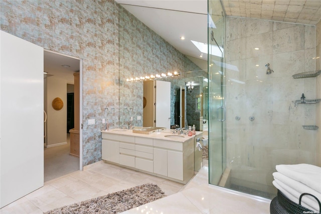 bathroom with tile patterned flooring, vanity, and walk in shower