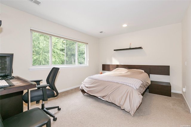 bedroom with light colored carpet