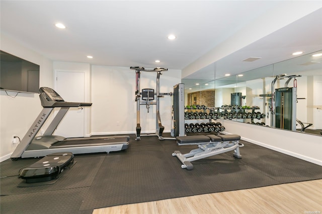 exercise room with hardwood / wood-style flooring