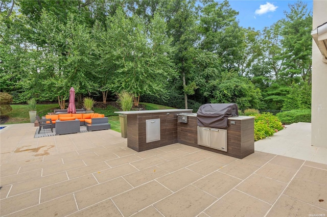 view of patio / terrace with an outdoor living space, exterior kitchen, and grilling area