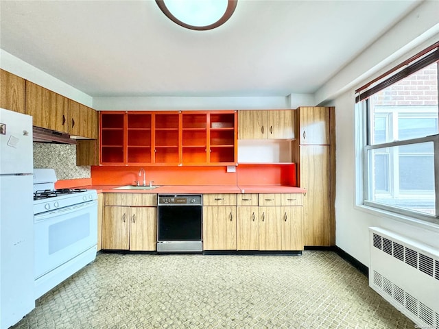 kitchen featuring radiator heating unit, white appliances, ventilation hood, and sink