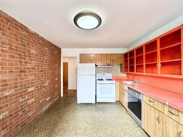 kitchen with extractor fan, white appliances, sink, and brick wall