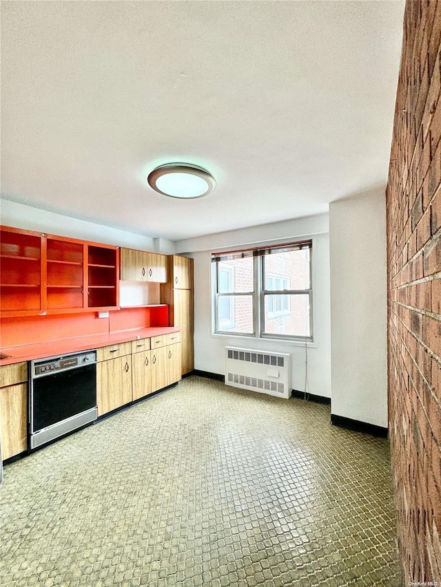 kitchen with dishwasher, a textured ceiling, and radiator