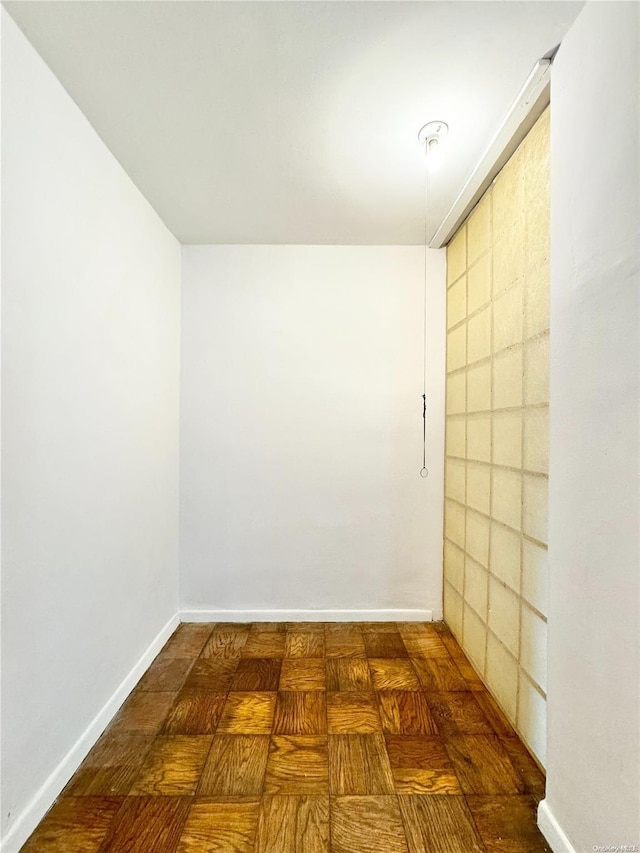 unfurnished room featuring dark parquet floors