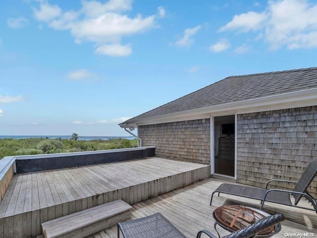 wooden deck featuring a water view