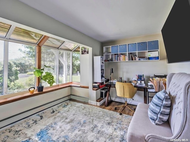 office area with baseboard heating and wood-type flooring