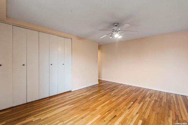 unfurnished bedroom with ceiling fan and light hardwood / wood-style floors