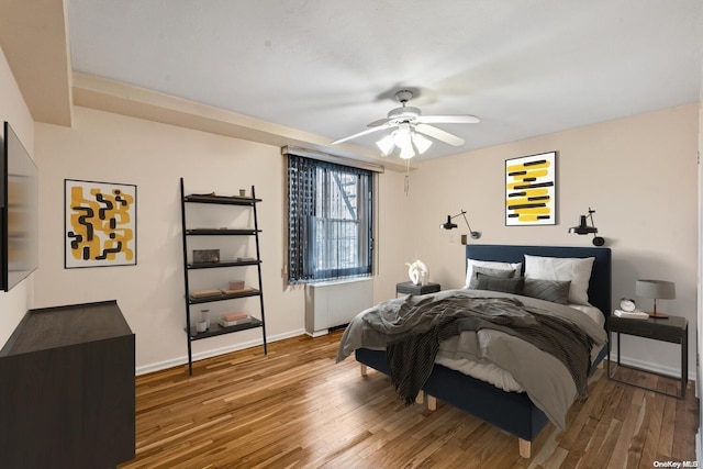 bedroom with hardwood / wood-style flooring and ceiling fan