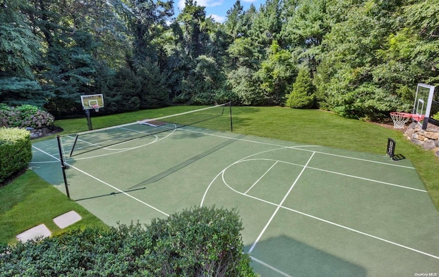 view of basketball court with a yard