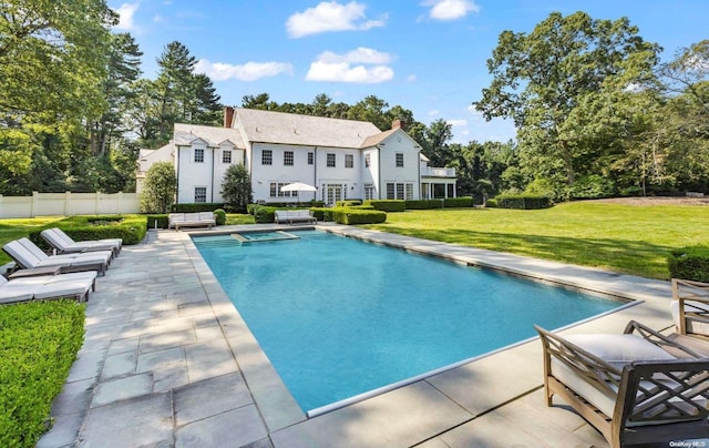 view of pool featuring a lawn and a patio