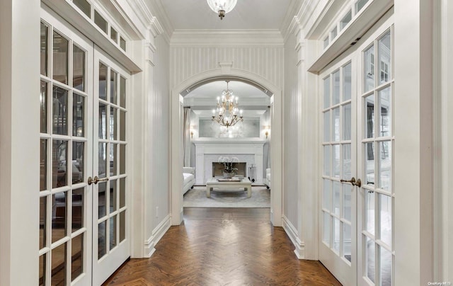 interior space featuring crown molding, french doors, and dark parquet floors